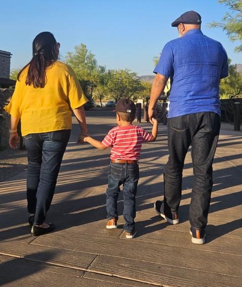A family walking together outdoors.