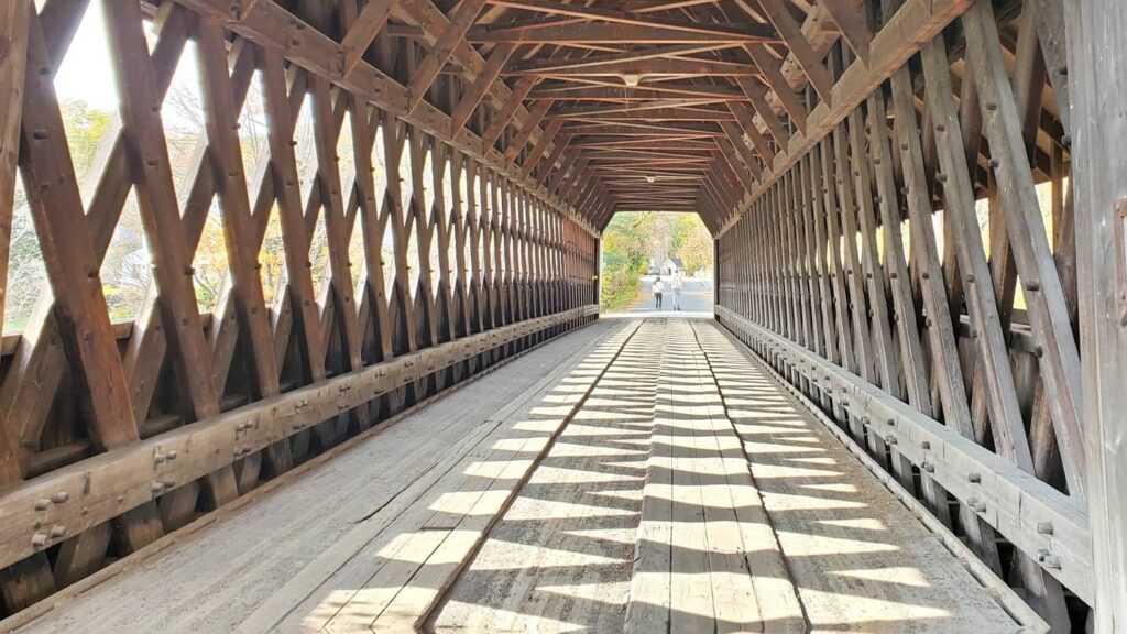 A covered bridge interior — the image behind our program's name.